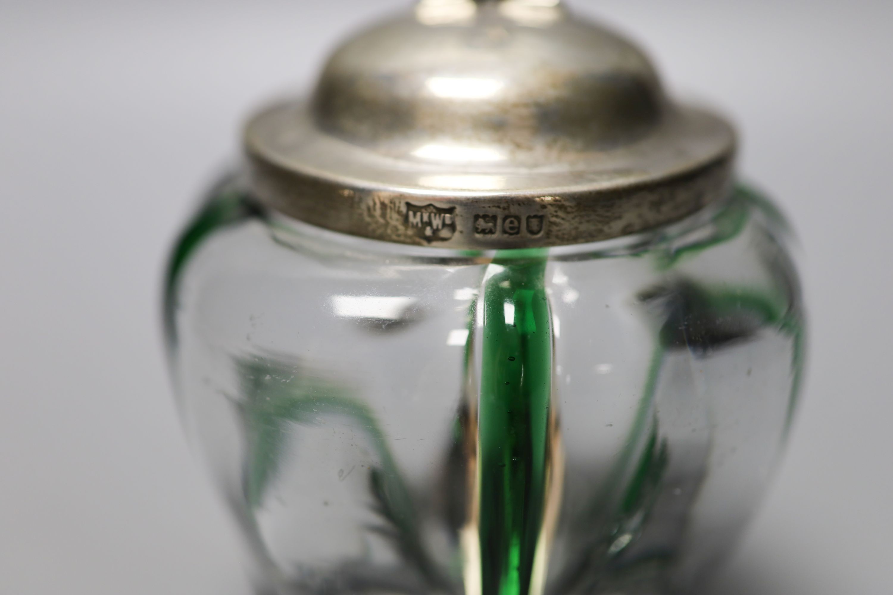 A late Victorian Art Nouveau silver mounted green and clear glass preserve pot, the glass probably James Powell & Sons, Mappin & Webb, London, 1900, 13.2cm, with later associated spoon